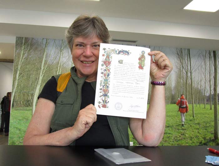 Anne Born receiving her latest Compostela in the Pilgrim Office of Santiago